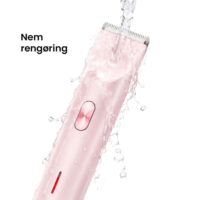 Skærehoved til Pink Kropstrimmer Ultra med keramiske knive, der skylles under rindende vand. Tekst: Nem rengøring.