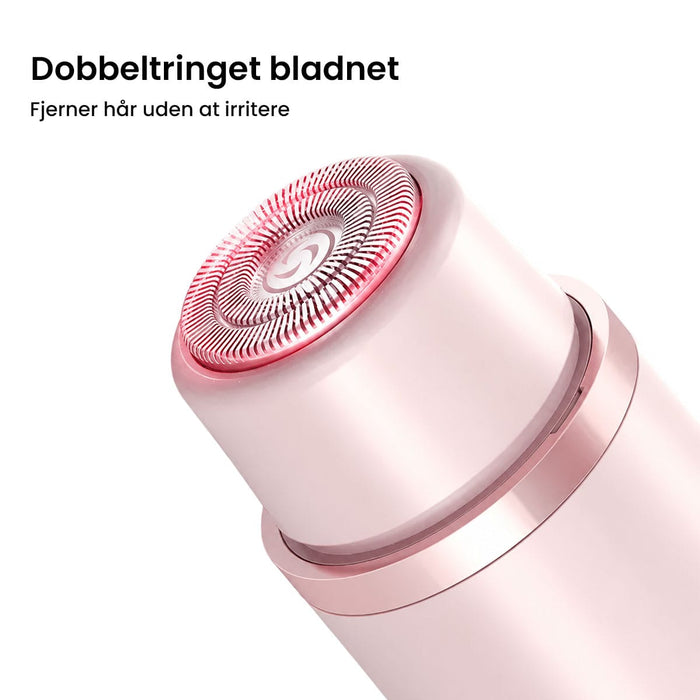 Nærbillede af et lyserødt Kropstrimmer Ultra-hoved med cirkulært dobbeltring-skær til ansigt og krop.
